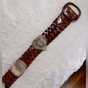 Genuine Leather belt with silver conchos and made in Italy.